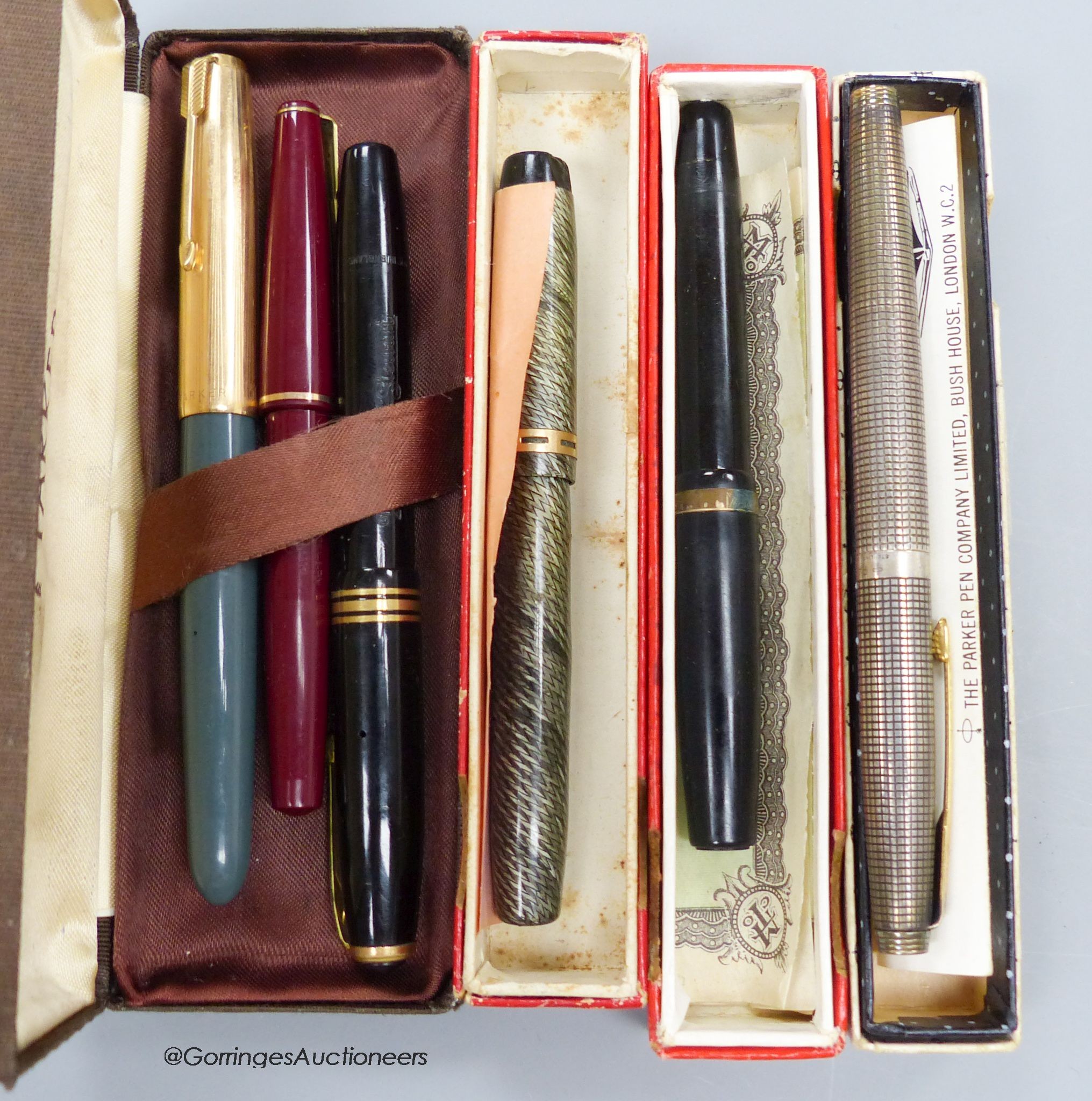 A silver parker pen together with five other pens